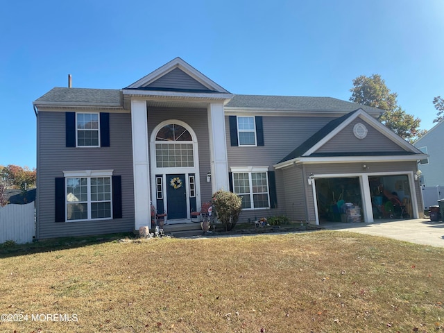 view of front of home with a garage and a front lawn