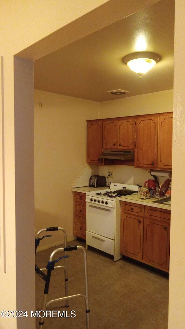 kitchen with white gas range oven