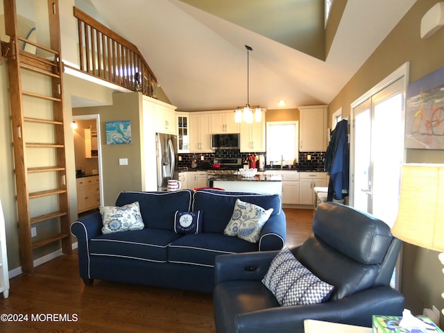 living room featuring dark hardwood / wood-style flooring, sink, high vaulted ceiling, and an inviting chandelier