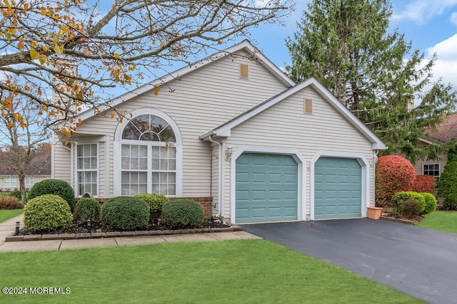 view of front facade featuring a front yard and a garage