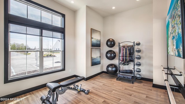 workout room with light hardwood / wood-style flooring