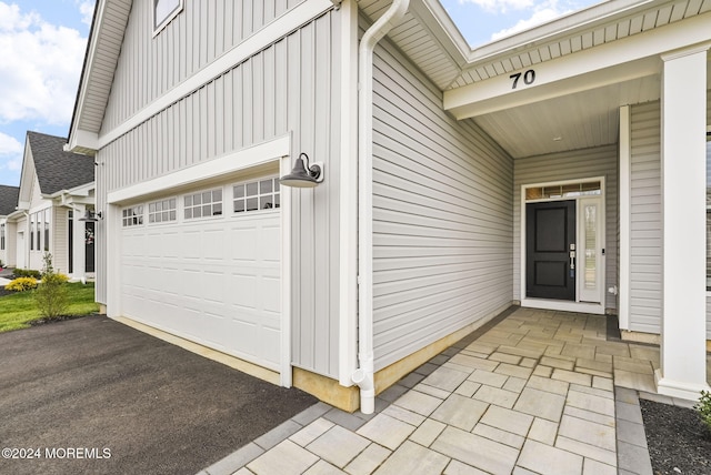 view of exterior entry featuring a garage