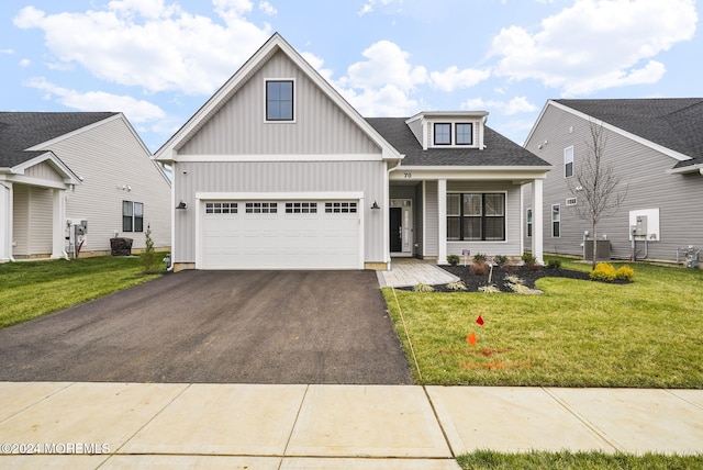 view of front of home featuring a garage and a front lawn