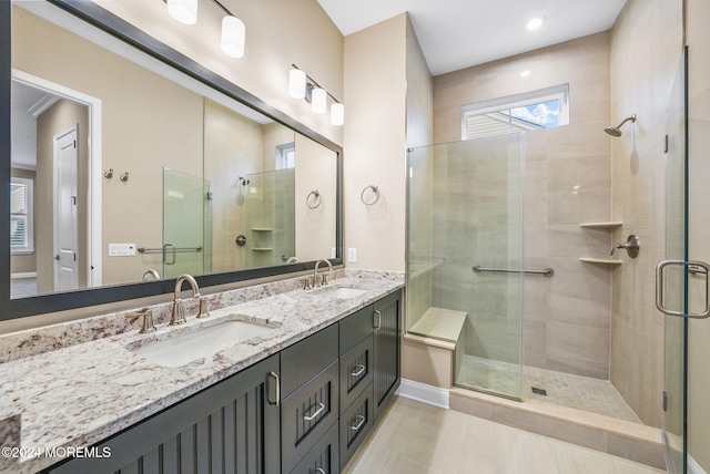 bathroom featuring vanity and a shower with shower door