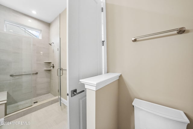 bathroom featuring walk in shower and toilet