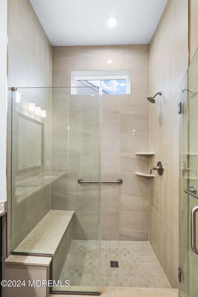 bathroom with a shower with door