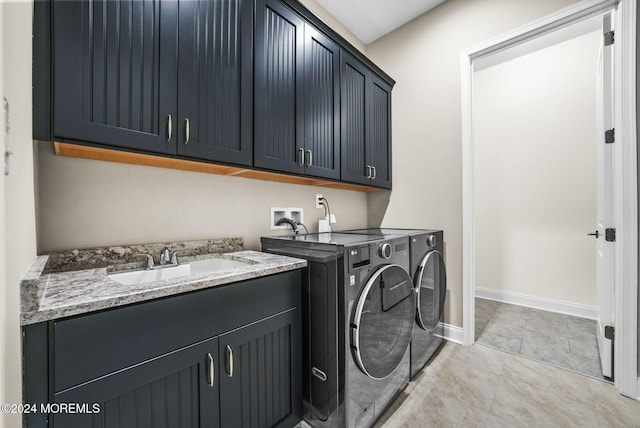 washroom with washer and clothes dryer, sink, and cabinets