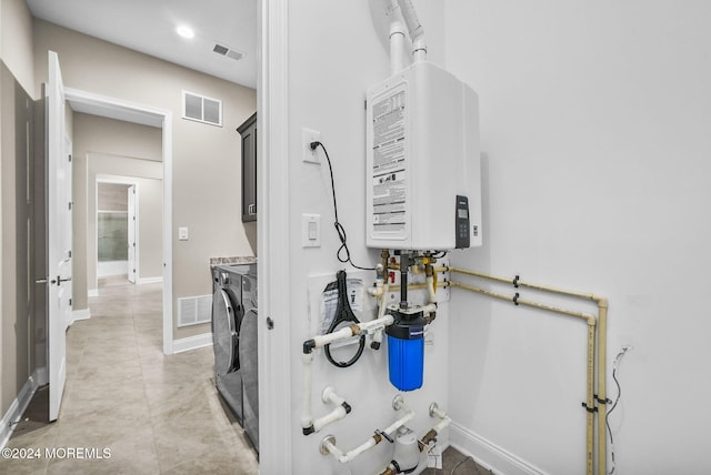 utilities featuring washer and dryer and tankless water heater