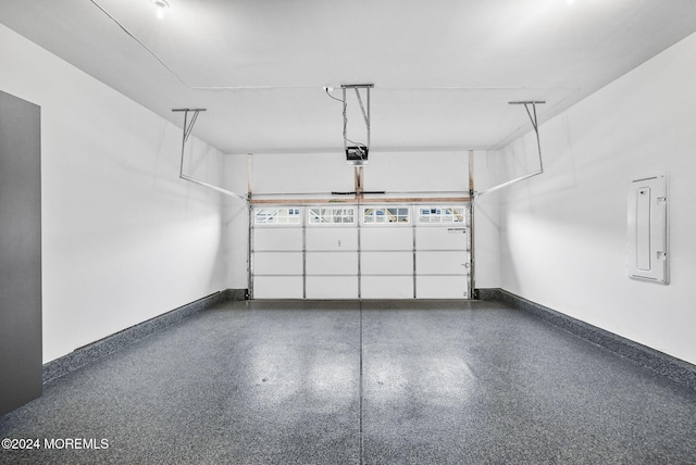 garage featuring electric panel and a garage door opener