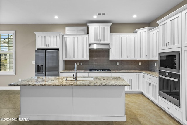 kitchen featuring white cabinets, appliances with stainless steel finishes, and a kitchen island with sink