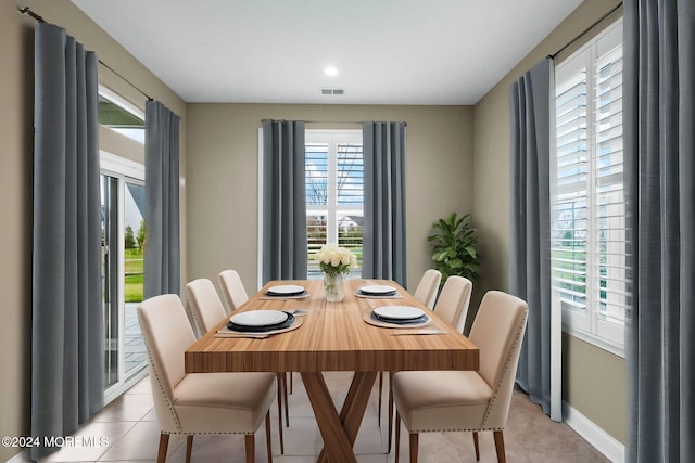 tiled dining room featuring a wealth of natural light