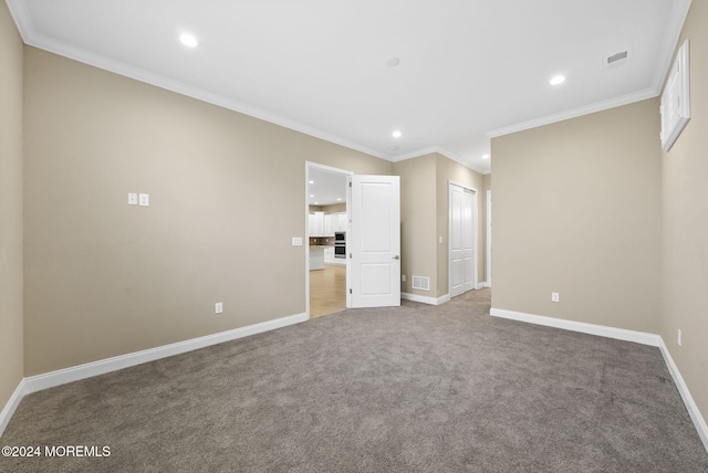 unfurnished bedroom featuring crown molding, a closet, and carpet floors