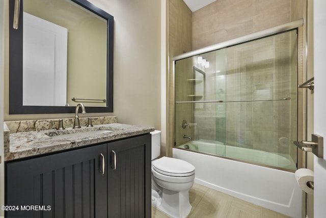 full bathroom with shower / bath combination with glass door, vanity, and toilet