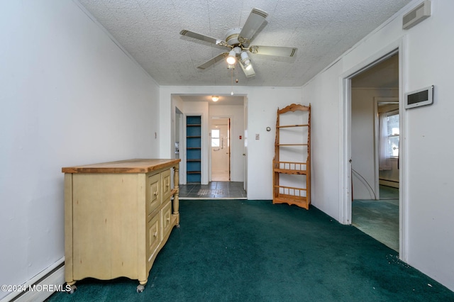 interior space featuring baseboard heating, ceiling fan, and a textured ceiling