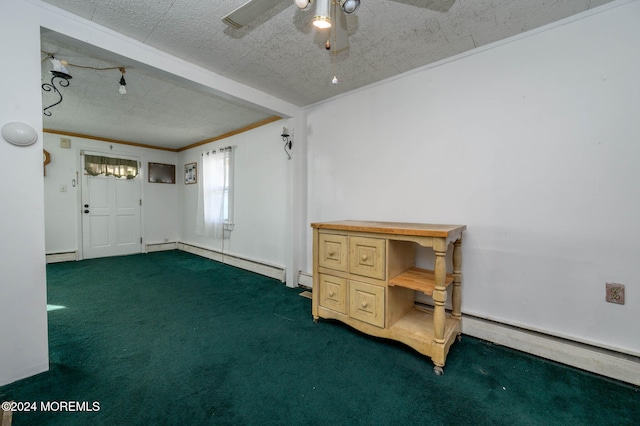 interior space with baseboard heating, ceiling fan, dark carpet, and a textured ceiling