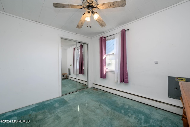 carpeted spare room featuring ceiling fan, crown molding, and baseboard heating