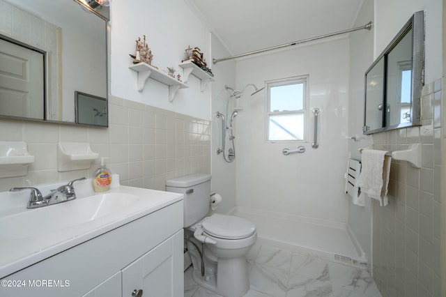 bathroom with vanity, decorative backsplash, toilet, tiled shower, and tile walls