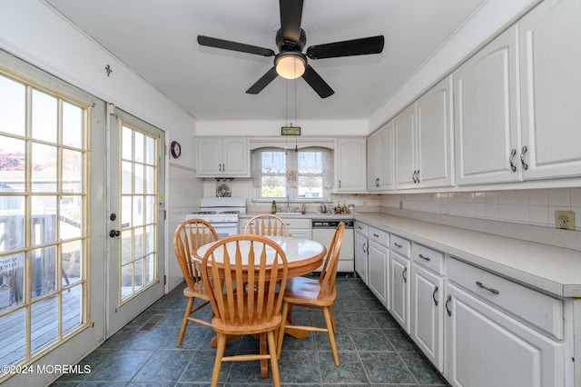 tiled dining space featuring ceiling fan and sink