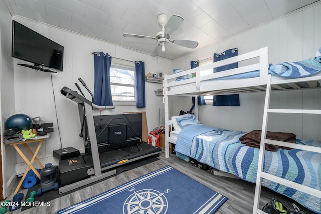 bedroom with ceiling fan and wood-type flooring