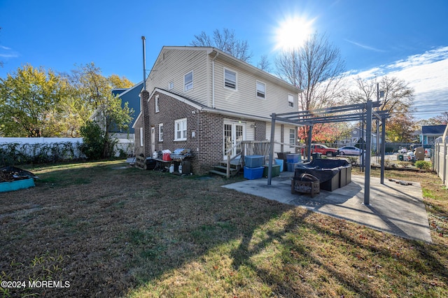 rear view of house featuring a patio area, a pergola, and a yard