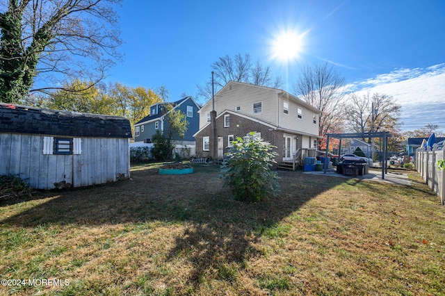 rear view of house with a yard, a storage shed, and a wooden deck