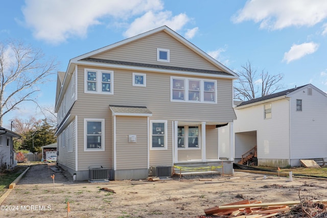 back of house with an outbuilding, cooling unit, a porch, and a garage