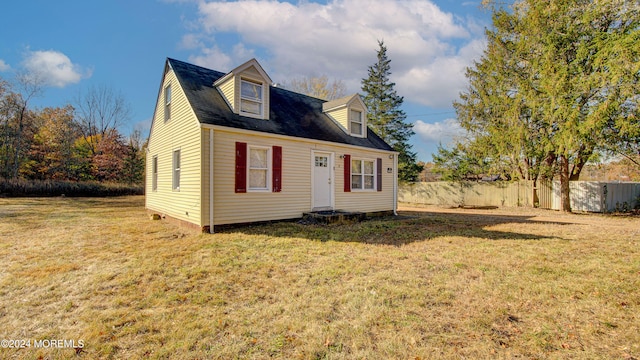 cape cod house with a front yard