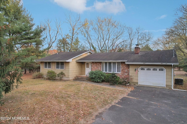 single story home with a garage and a front yard