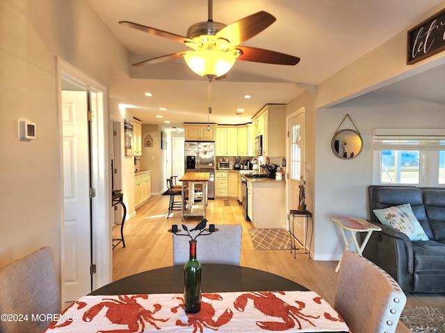 dining room featuring light hardwood / wood-style floors and ceiling fan