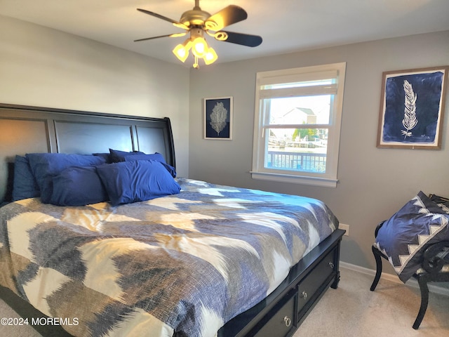 bedroom featuring light colored carpet and ceiling fan