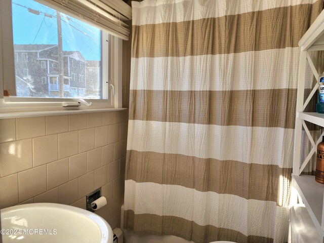 161 N Ensign Dr, Little Egg Harbor, NJ 08087 - bathroom featuring tile walls and a shower with curtain