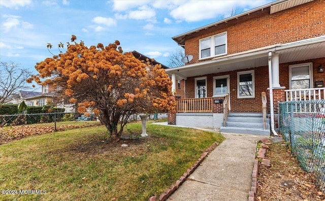 view of front of property with a porch and a front yard