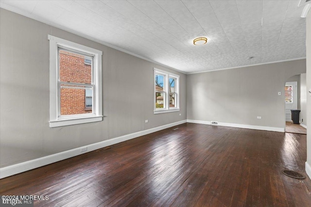 unfurnished room featuring hardwood / wood-style flooring and ornamental molding