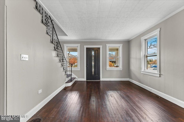 entryway featuring hardwood / wood-style flooring, plenty of natural light, and ornamental molding