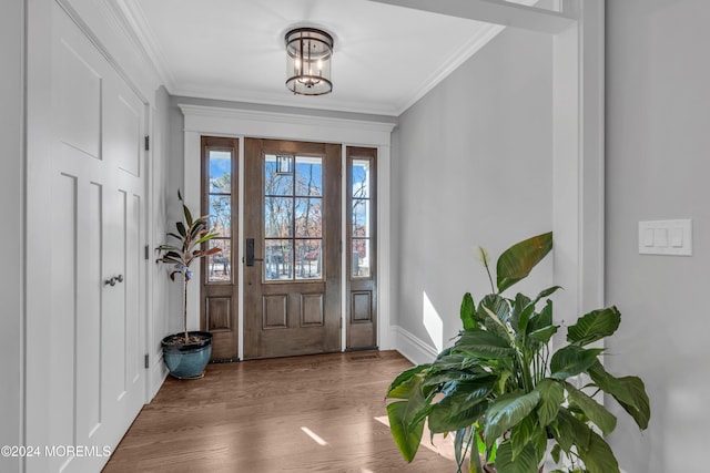 entryway featuring hardwood / wood-style floors and ornamental molding