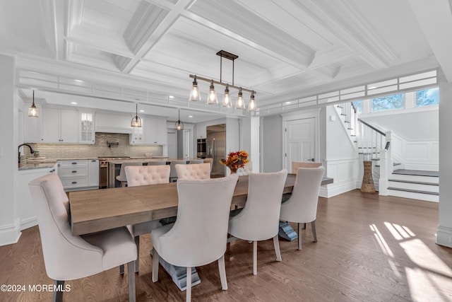 dining room featuring hardwood / wood-style floors, coffered ceiling, and beam ceiling