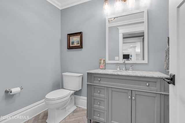 bathroom with vanity, toilet, parquet floors, and crown molding