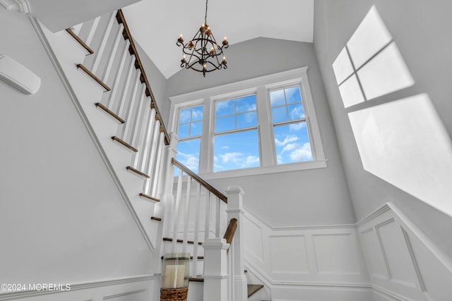 stairs featuring a notable chandelier