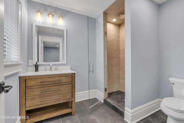 bathroom with tile patterned floors, vanity, toilet, and walk in shower