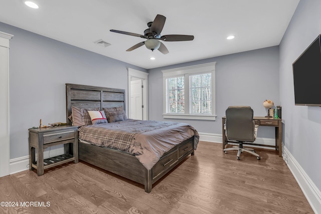 bedroom with ceiling fan and light hardwood / wood-style flooring