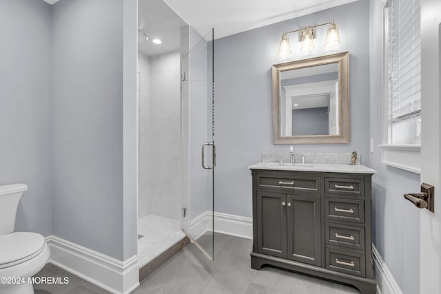 bathroom with vanity, toilet, and a shower with shower door