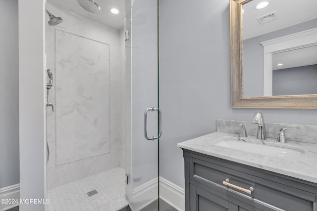 bathroom featuring vanity and an enclosed shower