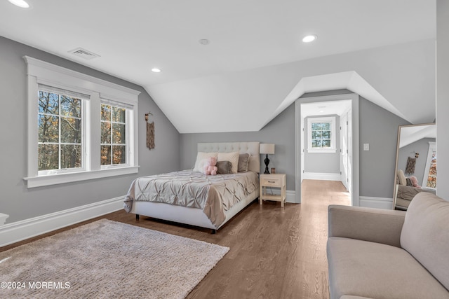 bedroom with dark hardwood / wood-style flooring and vaulted ceiling