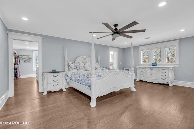 bedroom featuring hardwood / wood-style floors, ceiling fan, and crown molding