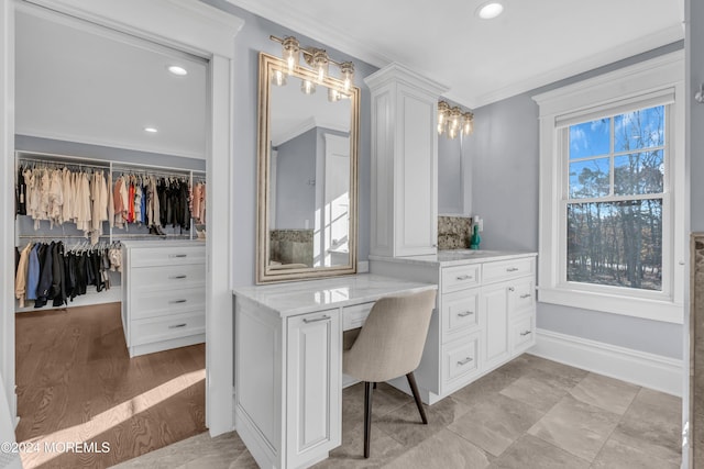 office area featuring built in desk and ornamental molding