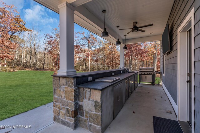 view of patio with area for grilling, ceiling fan, and sink