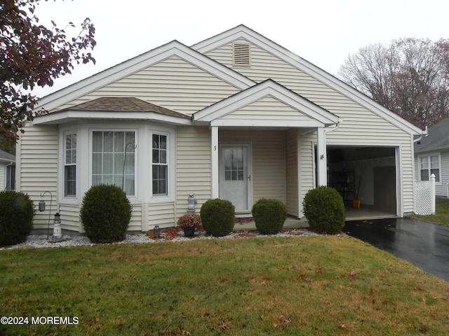 view of front of property with a garage and a front lawn