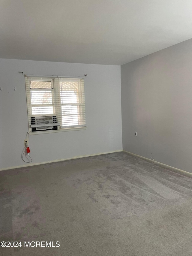 spare room with cooling unit and carpet floors