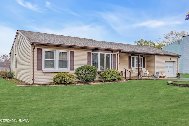 ranch-style house with a front lawn, covered porch, and a garage