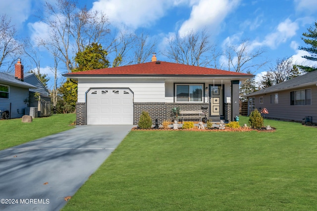 view of front of property with a garage and a front yard